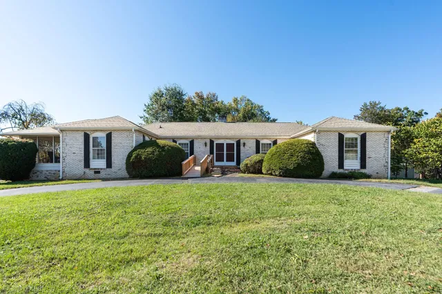 a front view of house with yard and trees