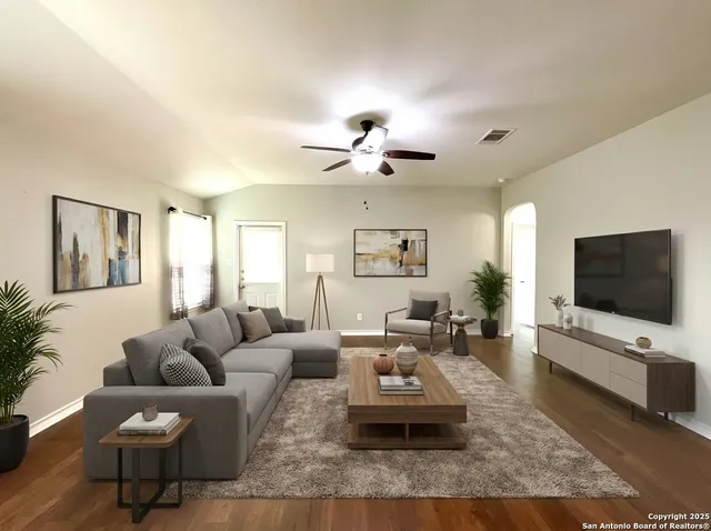 a living room with furniture and a flat screen tv