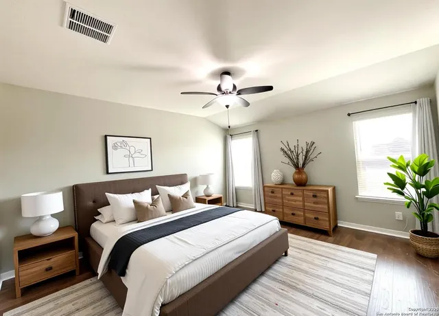 a bedroom with bed and a potted plant