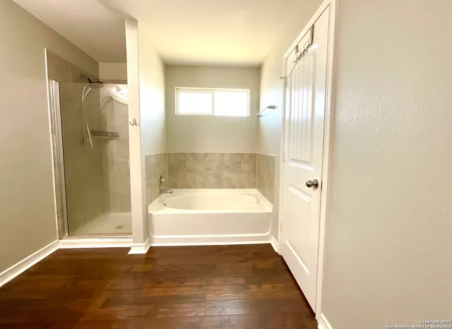 a bathroom with a bathtub and a shower