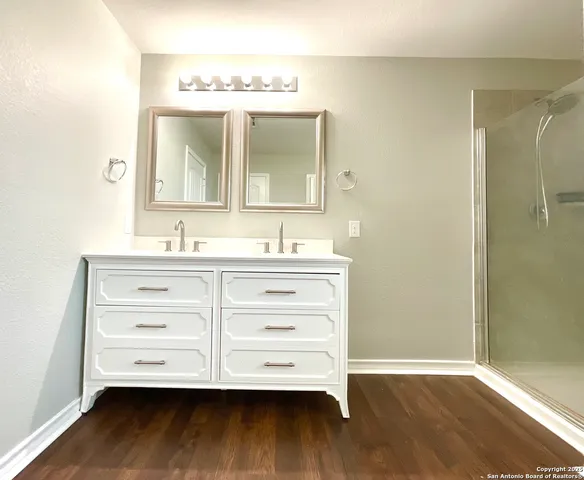 a bathroom with a vanity mirror and a sink