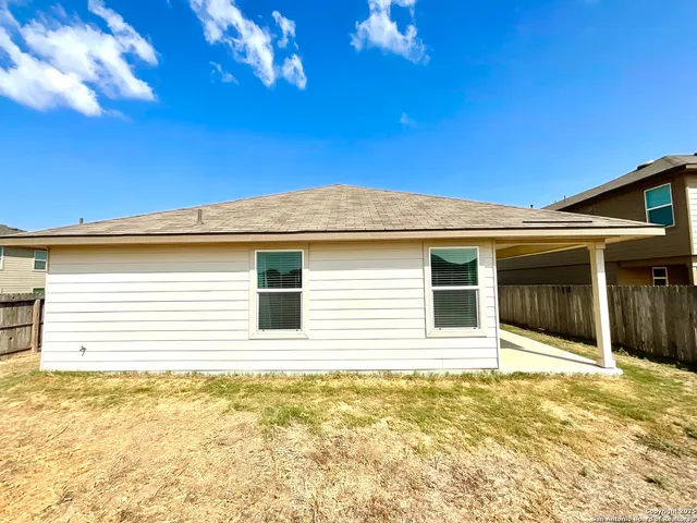 a view of a house with a backyard