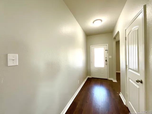 a view of a hallway with wooden floor