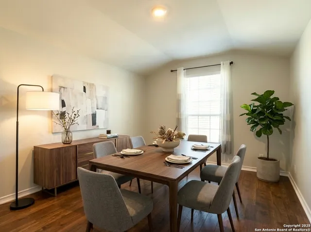 a dining room with furniture and window