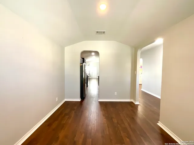 a view of a room with wooden floor