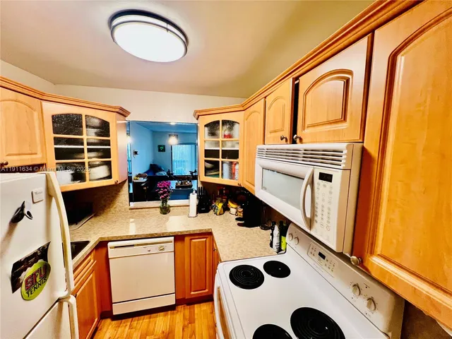 a kitchen with a sink a stove and cabinets