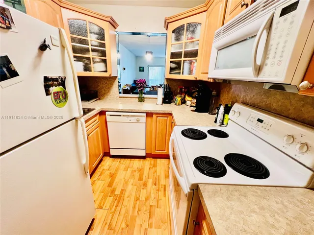 a kitchen with a refrigerator a stove a sink and a cabinets