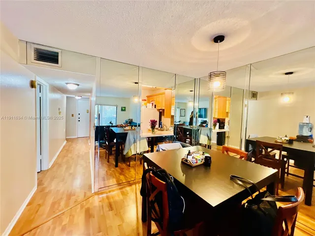 a view of a dining hall with dining table and chairs
