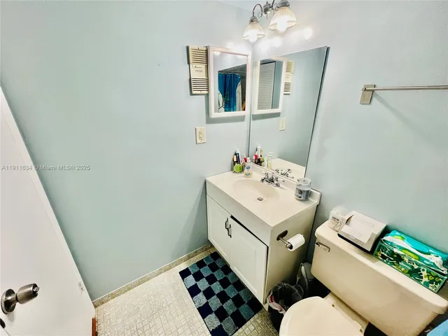 a bathroom with a sink toilet and mirror