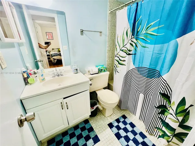 a bathroom with a sink a mirror and a toilet