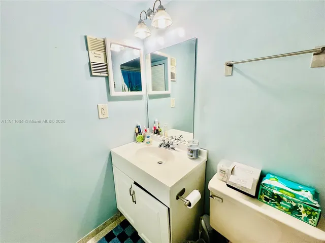 a bathroom with a sink mirror and vanity