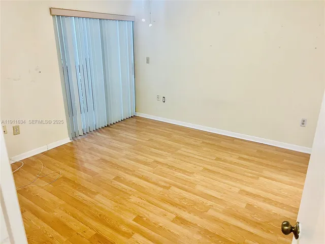 a view of hallway with wooden floor