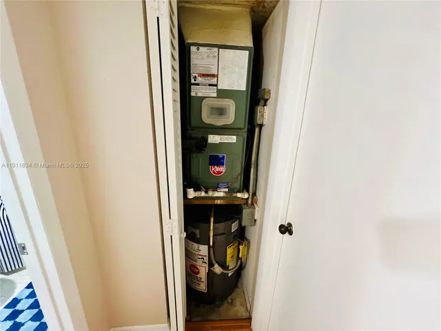 a view of a hallway with wooden floor and living room