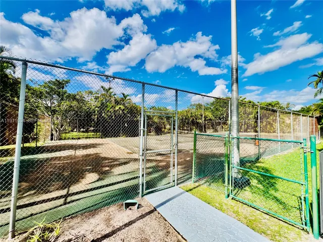a view of a swimming pool with a lounge chair and potted plants