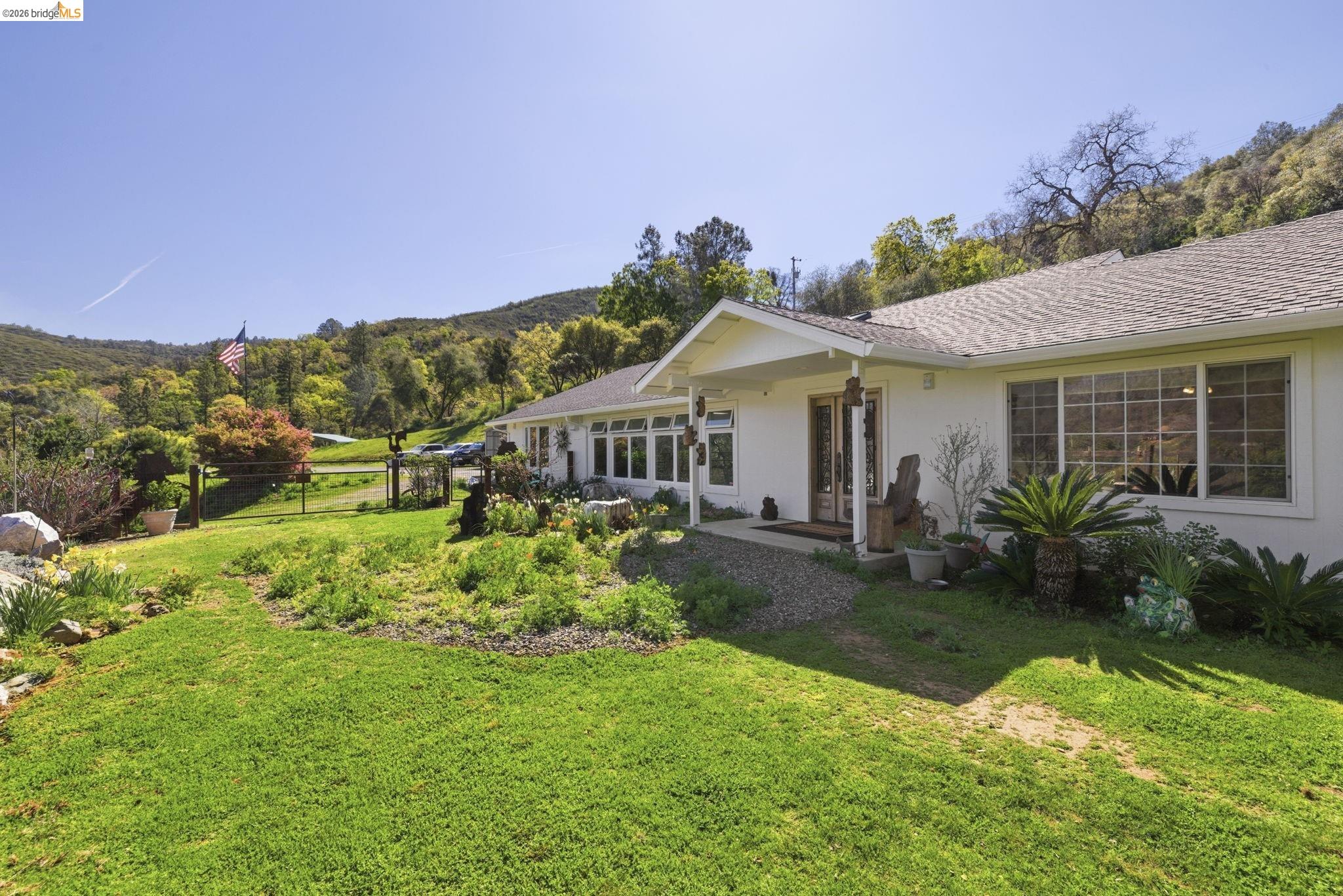 5356 Dogtown Road Coulterville, CA 95311 - Photo 11 of 60 a front view of a house with garden
