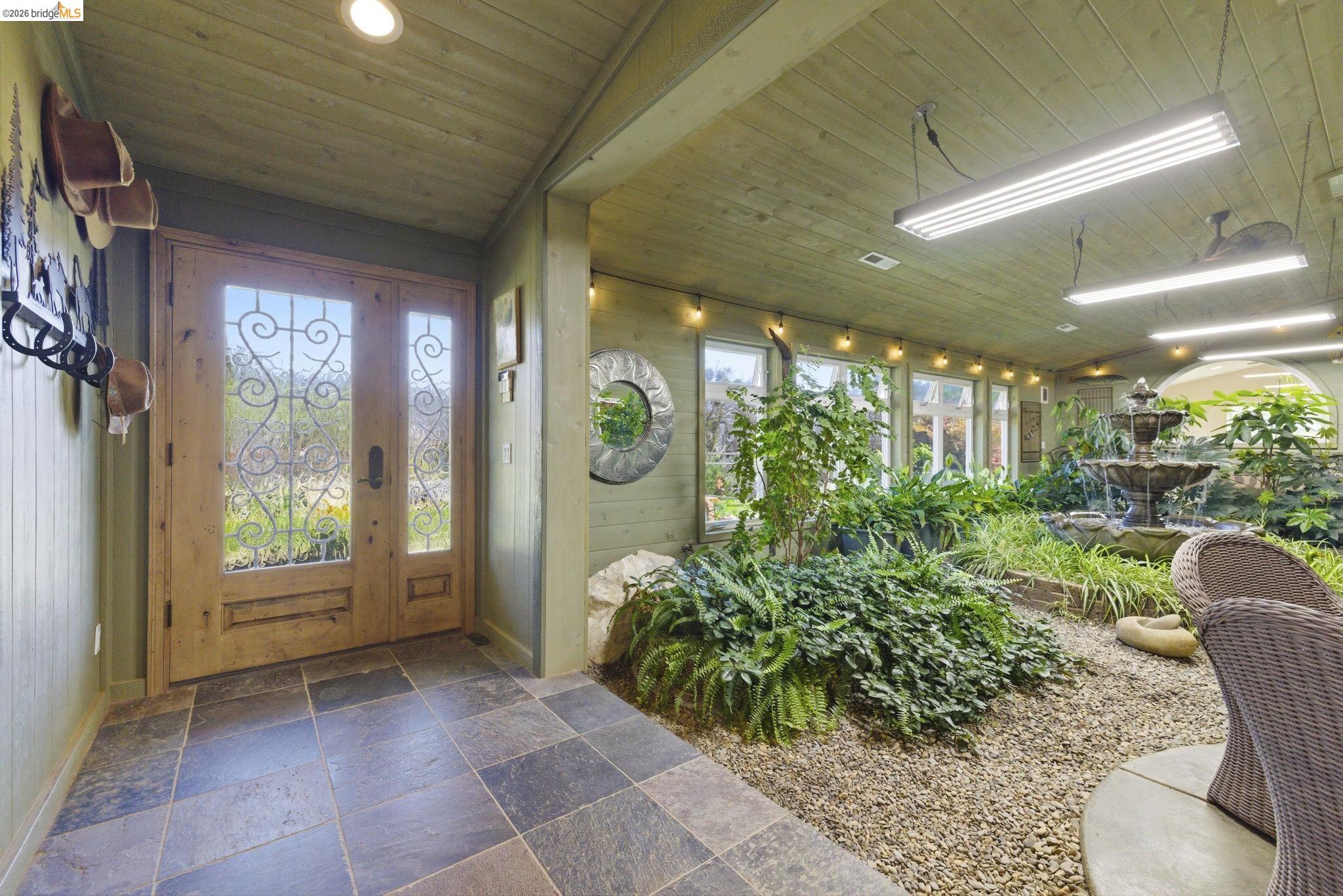5356 Dogtown Road Coulterville, CA 95311 - Photo 16 of 60 a view of a porch with chairs and floor to ceiling window