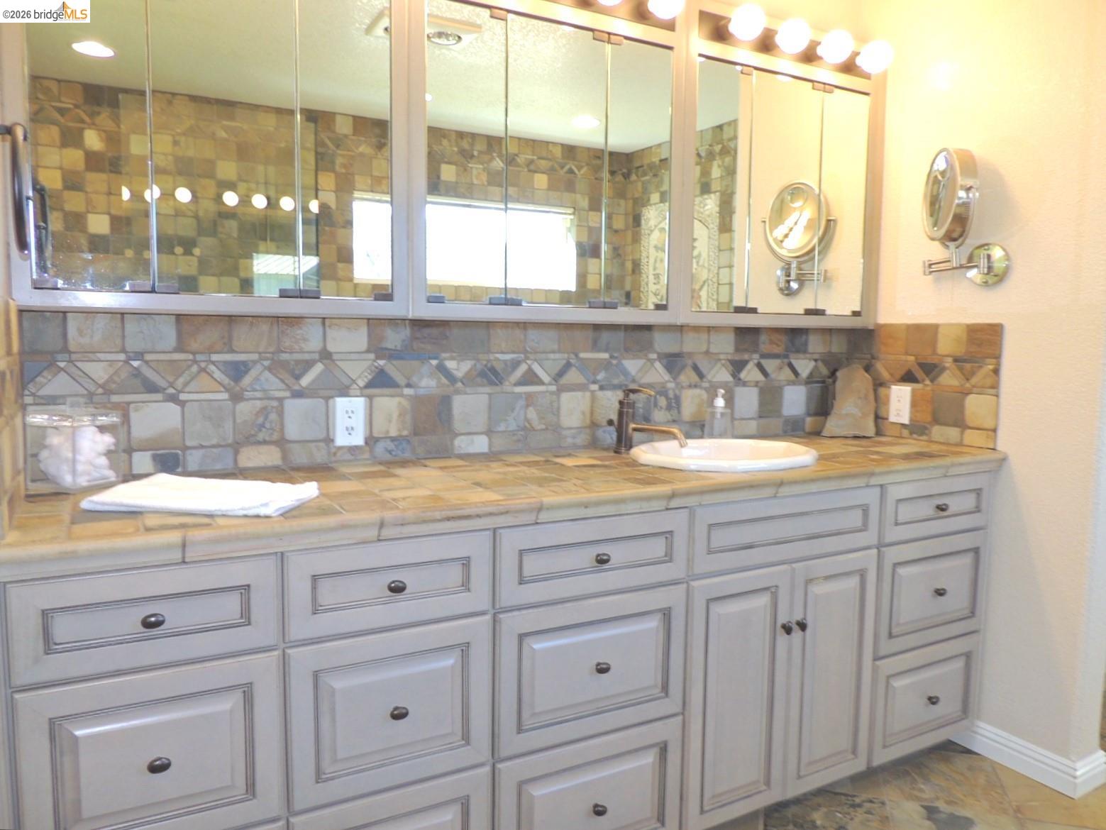 5356 Dogtown Road Coulterville, CA 95311 - Photo 43 of 60 a bathroom with a granite countertop sink mirror and