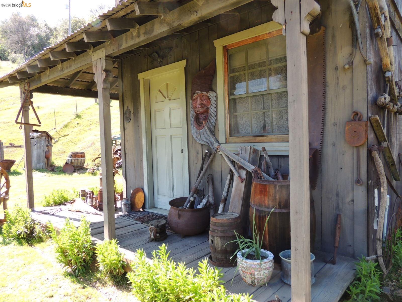 5356 Dogtown Road Coulterville, CA 95311 - Photo 54 of 60 a view of a porch with furniture and floor to ceiling window