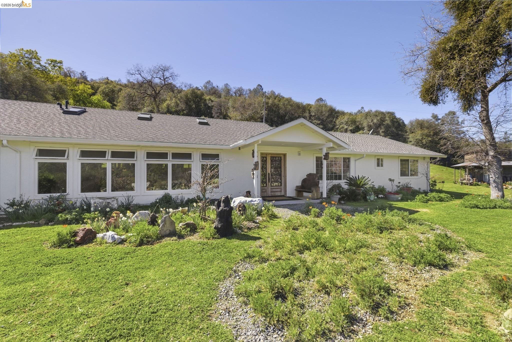5356 Dogtown Road Coulterville, CA 95311 - Photo 9 of 60 a front view of a house with a garden