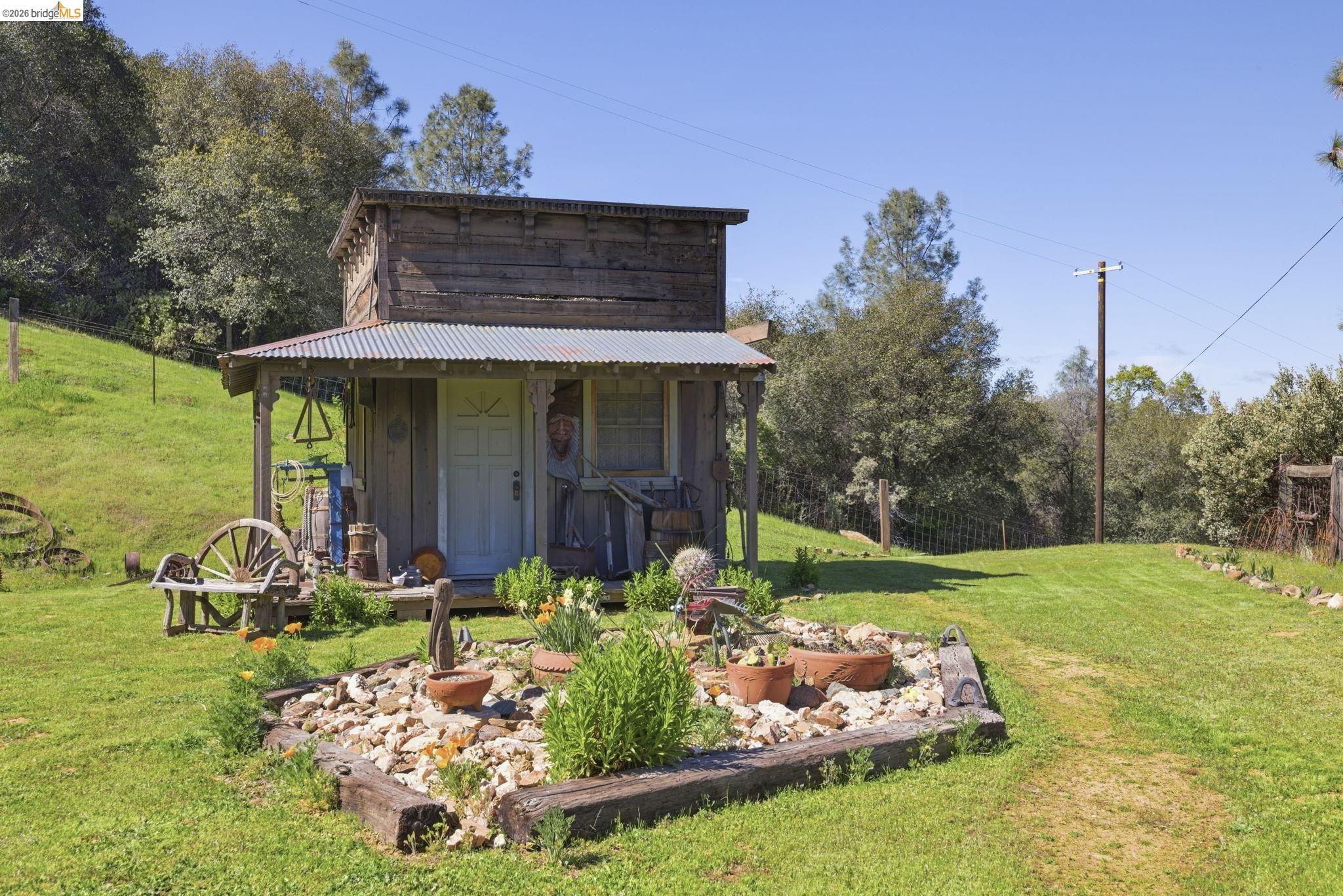 5356 Dogtown Road Coulterville, CA 95311 - Photo 10 of 60 a view of a backyard with plants and a garden