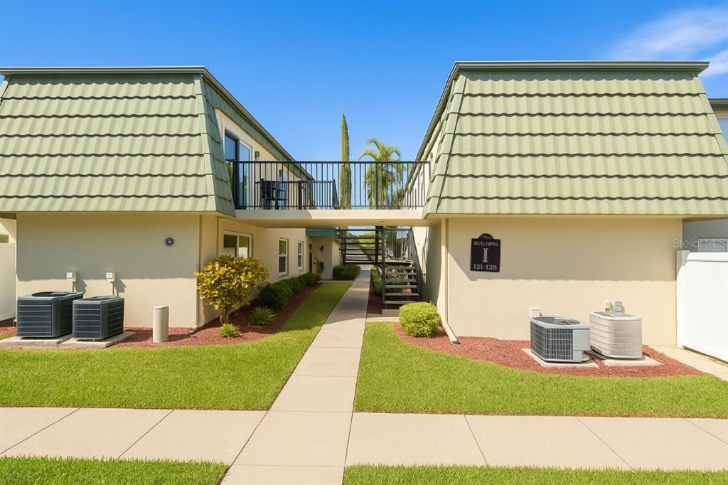 1799 North Highland Avenue, Unit 126 Clearwater, FL 33755 - Photo 1 of 20 a front view of a house with a yard