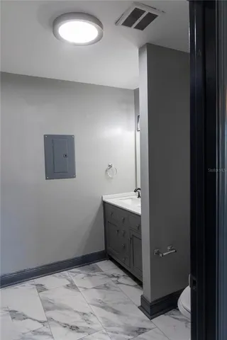 a bathroom with a sink and mirror