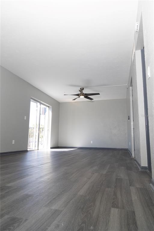 1799 North Highland Avenue, Unit 126 Clearwater, FL 33755 - Photo 5 of 20 a view of an empty room with wooden floor and a window
