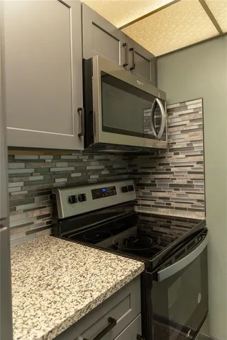 a stove top oven sitting inside of a kitchen