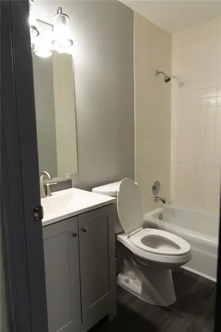 a bathroom with a toilet a sink and mirror