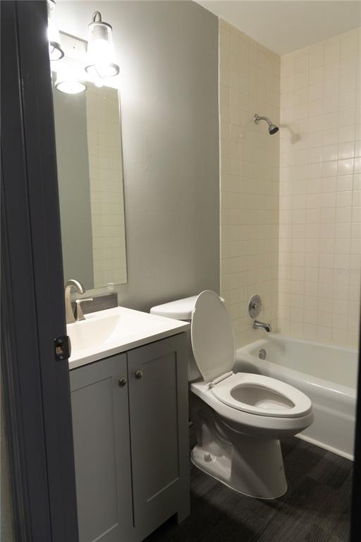 1799 North Highland Avenue, Unit 126 Clearwater, FL 33755 - Photo 10 of 20 a bathroom with a toilet a sink and mirror