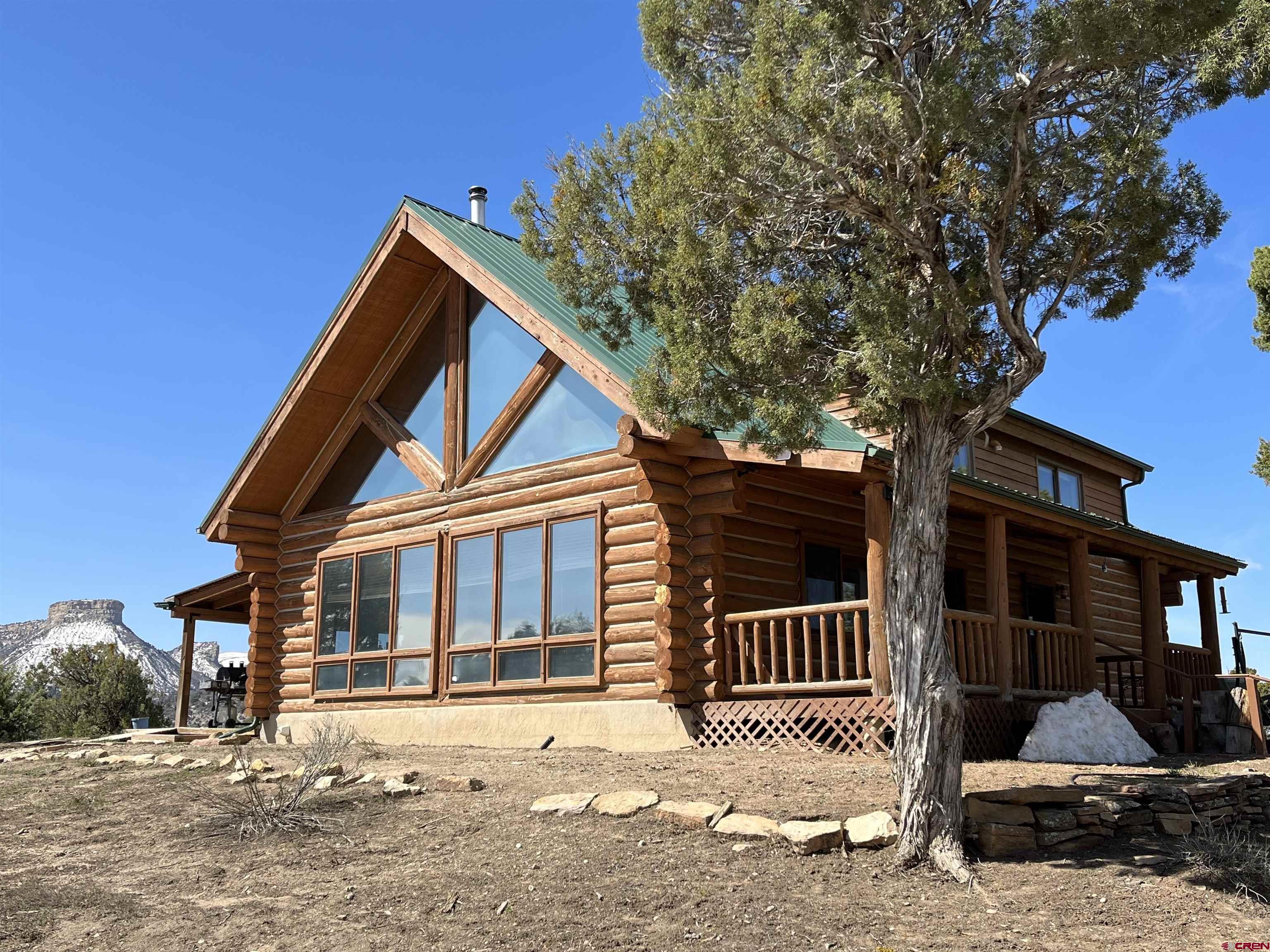 9571 Road 35 Mancos, CO 81328 - Photo 1 of 32 a front view of a house with a yard