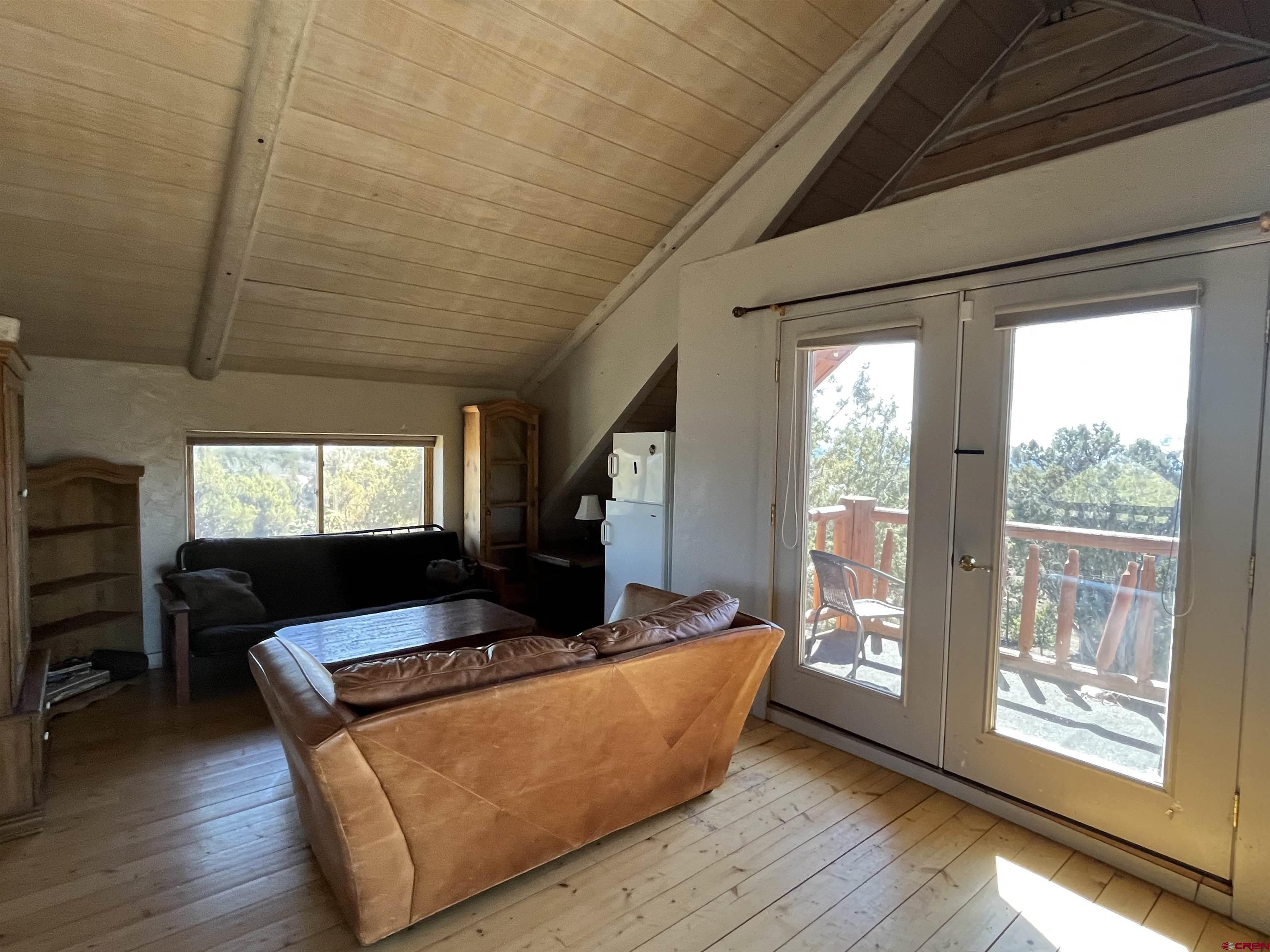 9571 Road 35 Mancos, CO 81328 - Photo 15 of 32 a living room with furniture and a flat screen tv