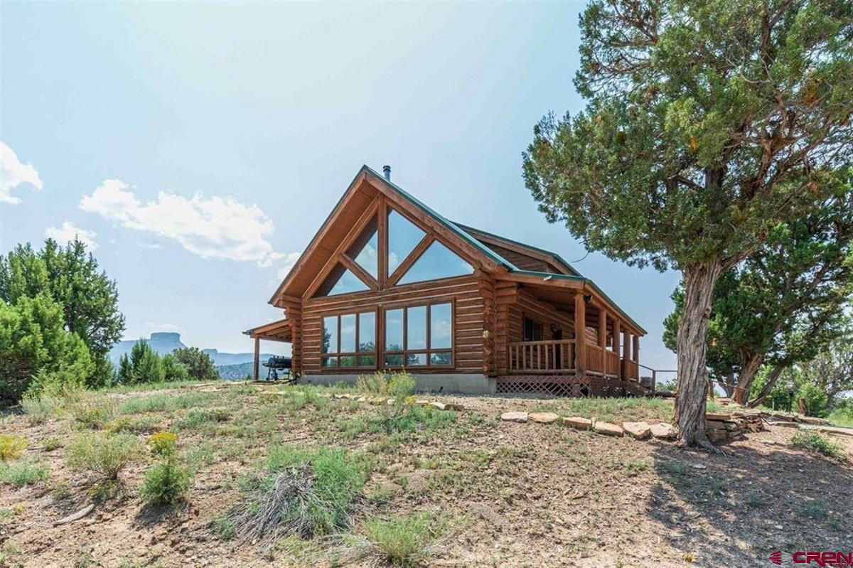 9571 Road 35 Mancos, CO 81328 - Photo 2 of 32 a front view of a house with a yard