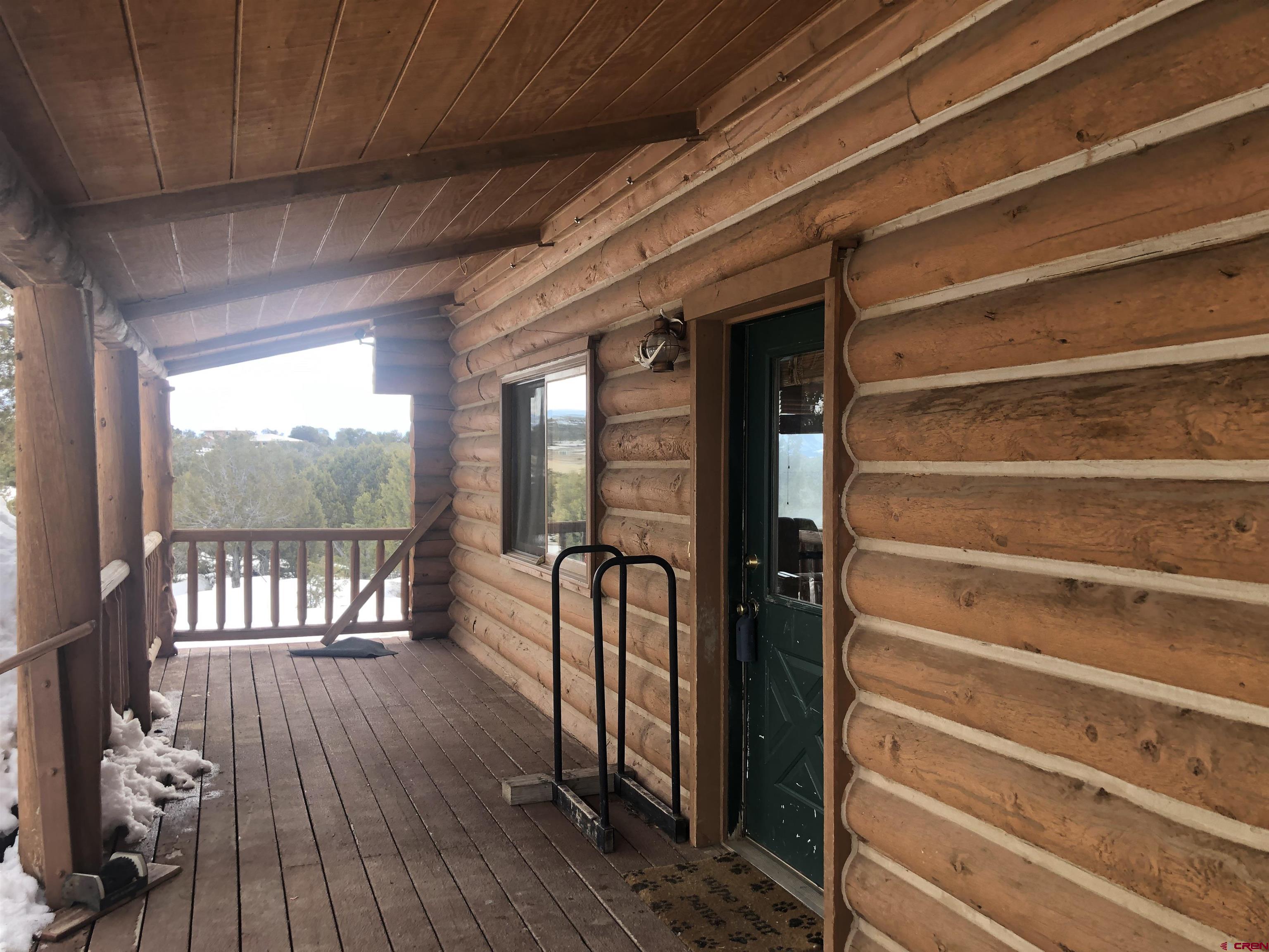 9571 Road 35 Mancos, CO 81328 - Photo 21 of 32 a view of walk in closet with wooden floor and a window