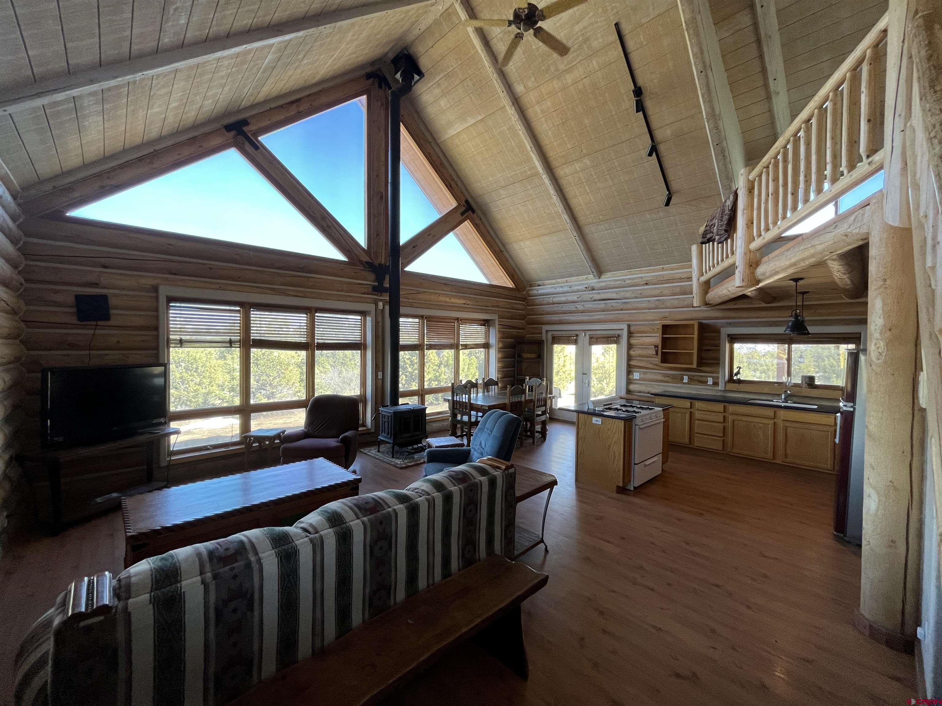 9571 Road 35 Mancos, CO 81328 - Photo 10 of 32 a living room with furniture a flat screen tv and windows