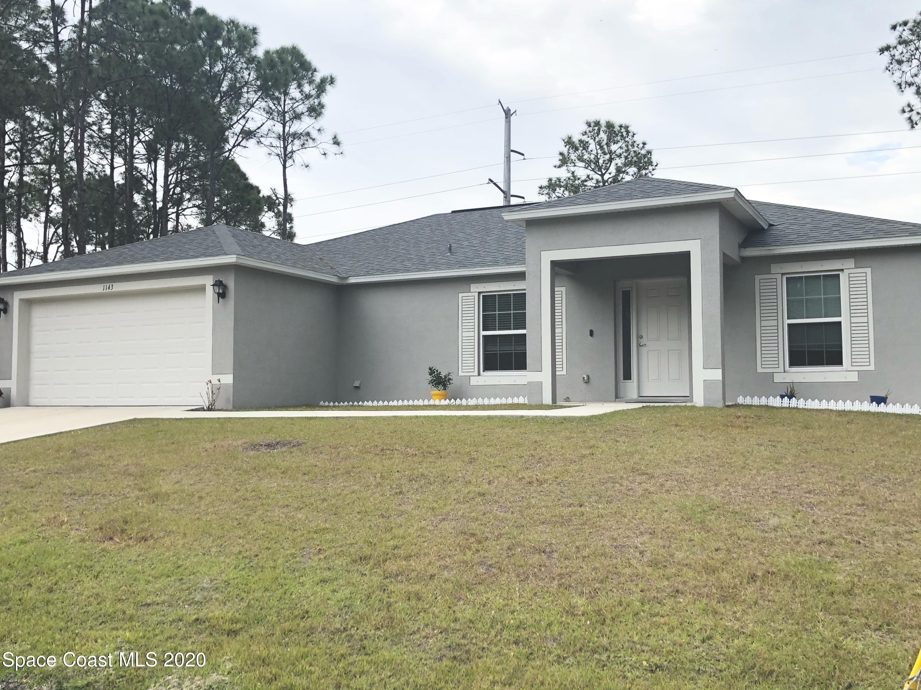 1143 Harlingen Road Southwest, Unit 32 Palm Bay, FL 32908 - Photo 2 of 11 a house that has a lot of windows in it