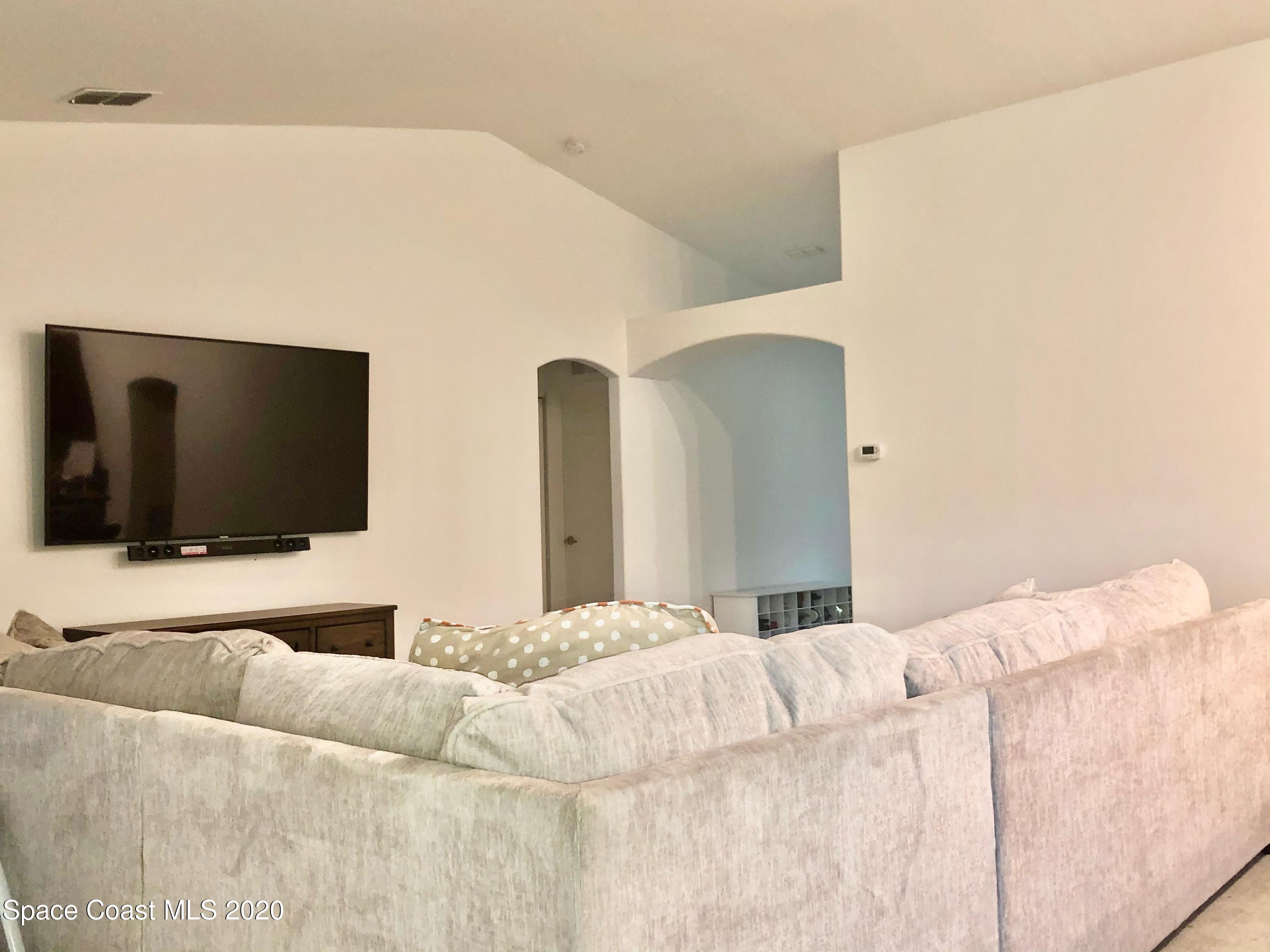 1143 Harlingen Road Southwest, Unit 32 Palm Bay, FL 32908 - Photo 5 of 11 a bedroom with a bed and a flat screen tv