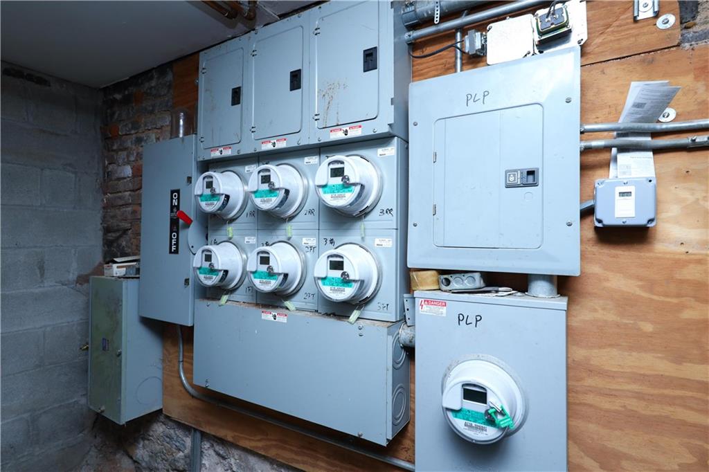 1748 79th Street Brooklyn, NY 11214 - Photo 11 of 20 a utility room with lots of clutter and cabinets