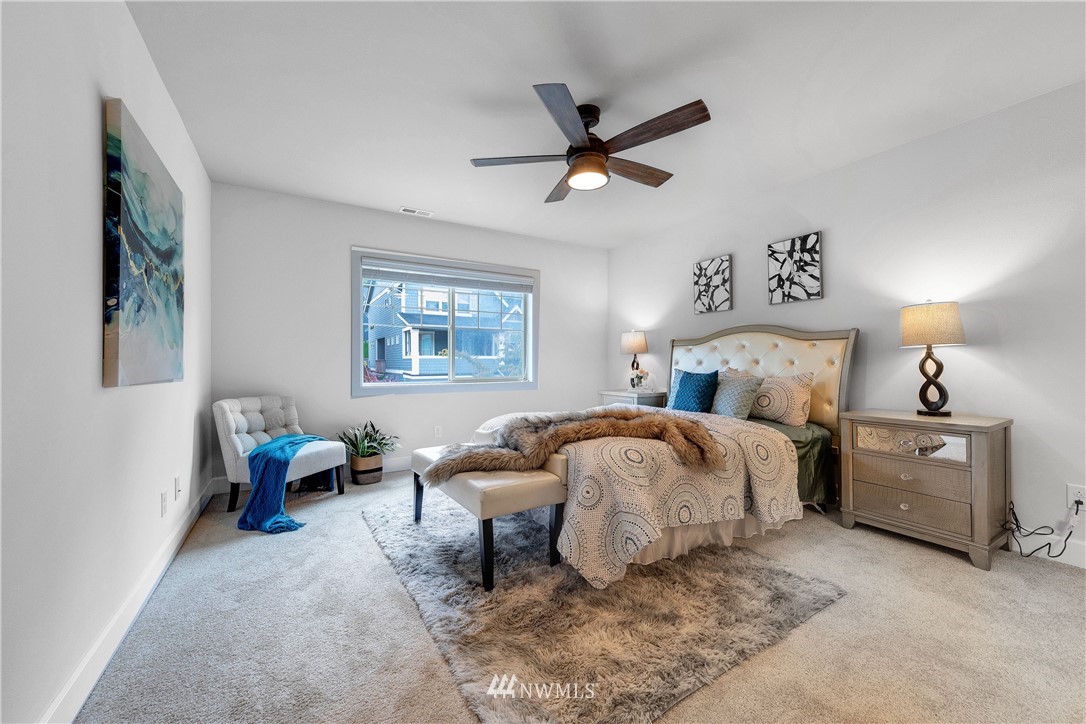 20057 94th Avenue Northeast, Unit 36 Bothell, WA 98011 - Photo 16 of 31 a spacious bedroom with a bed and a chandelier