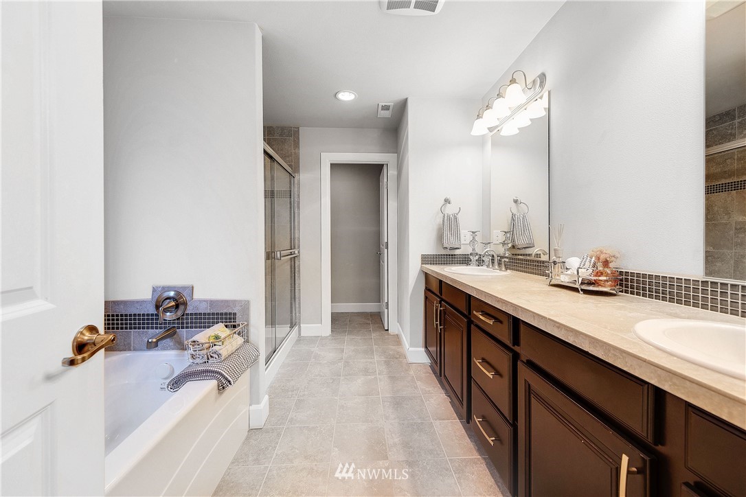 20057 94th Avenue Northeast, Unit 36 Bothell, WA 98011 - Photo 17 of 31 a spacious bathroom with a tub double sink and mirror