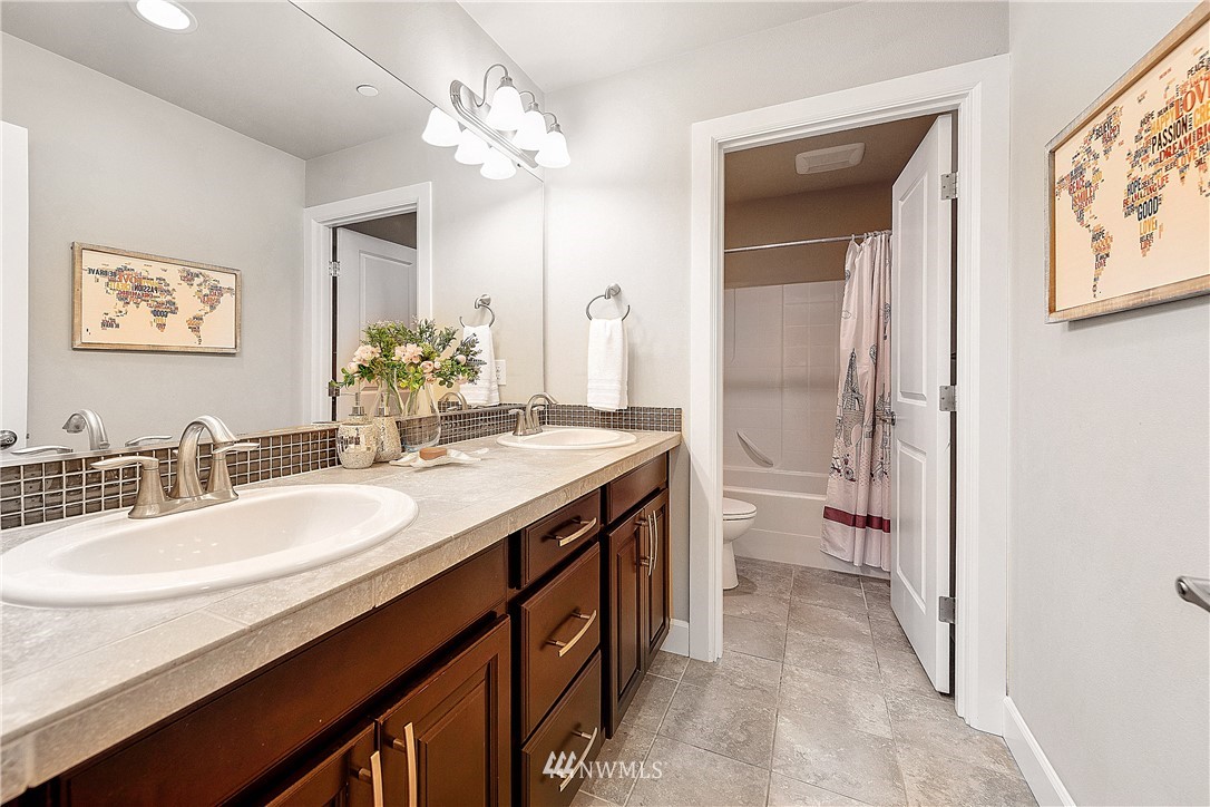 20057 94th Avenue Northeast, Unit 36 Bothell, WA 98011 - Photo 23 of 31 a bathroom with a granite countertop sink a toilet and a mirror