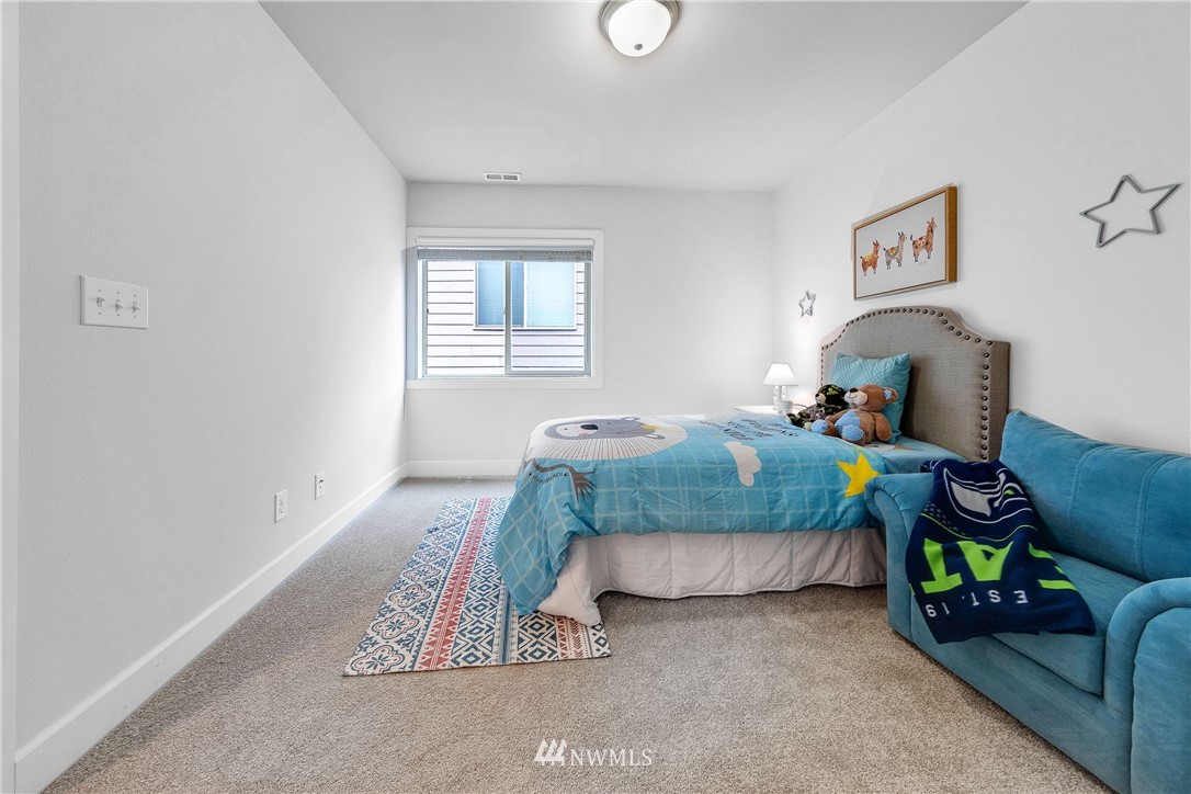 20057 94th Avenue Northeast, Unit 36 Bothell, WA 98011 - Photo 26 of 31 a bedroom with bed and a window