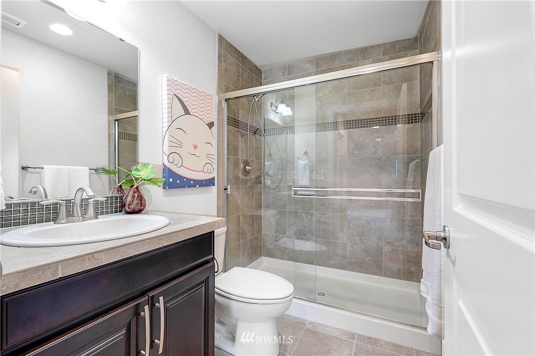 20057 94th Avenue Northeast, Unit 36 Bothell, WA 98011 - Photo 27 of 31 a bathroom with a sink a toilet and a mirror
