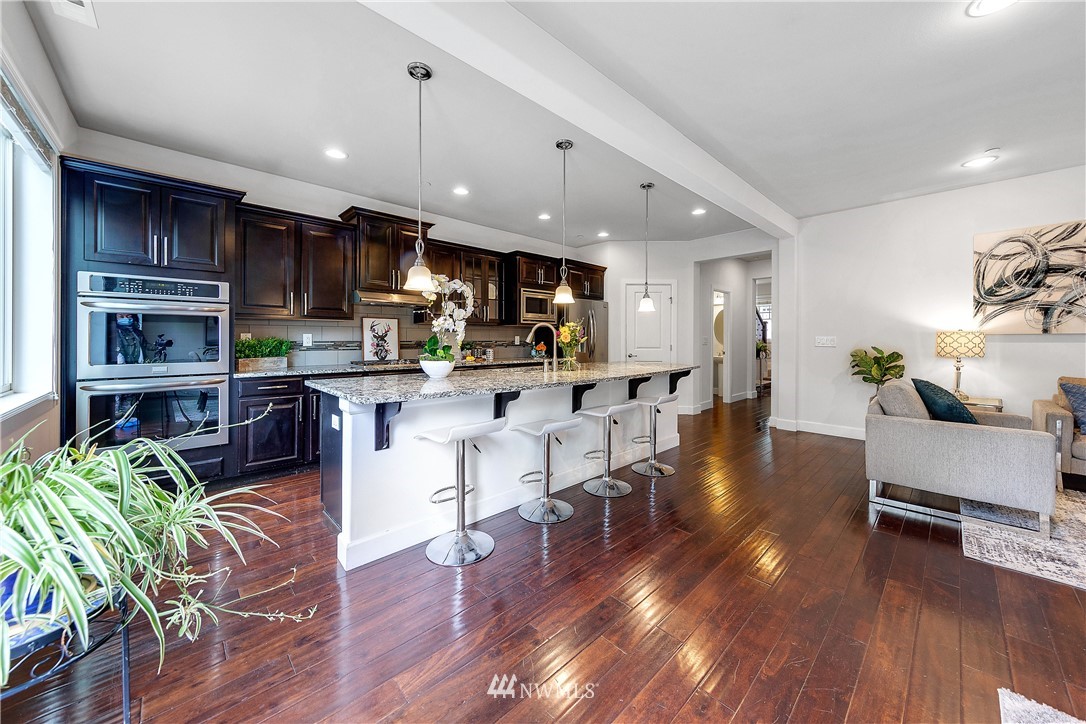 20057 94th Avenue Northeast, Unit 36 Bothell, WA 98011 - Photo 6 of 31 a living room with stainless steel appliances kitchen island wooden floors kitchen view and a window