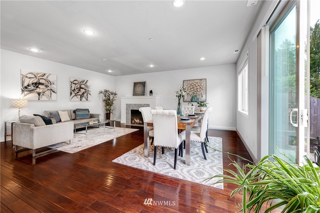 20057 94th Avenue Northeast, Unit 36 Bothell, WA 98011 - Photo 8 of 31 a living room with furniture a fireplace and a large window