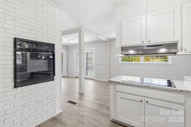 a kitchen with stainless steel appliances granite countertop a stove and a refrigerator