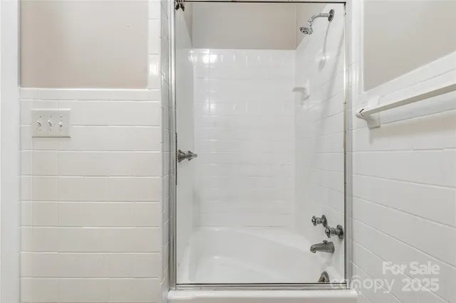 a bathroom with a glass shower door