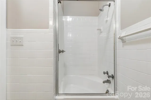 a bathroom with a glass shower door