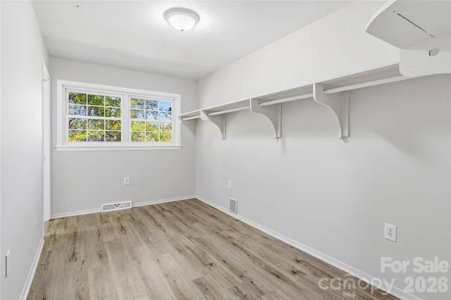 a view of a room with wooden floor and windows
