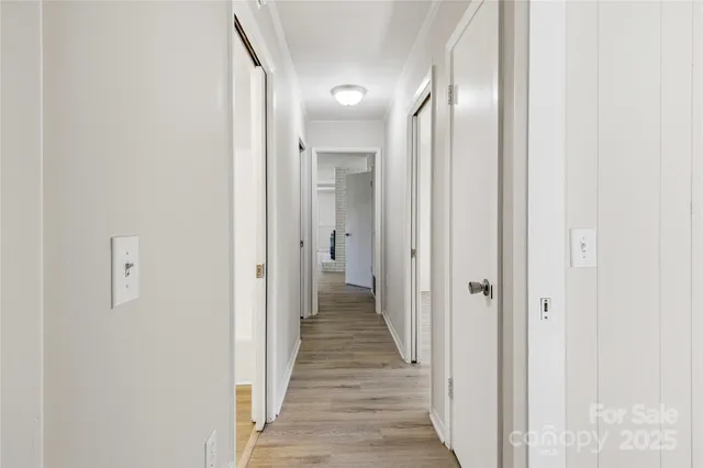 a view of a hallway with wooden floor